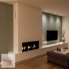 a living room filled with furniture and a flat screen tv mounted on the wall next to a fire place