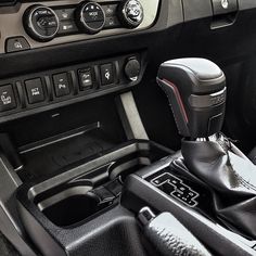 the interior of a car with an automatic gear box and control knobs on it