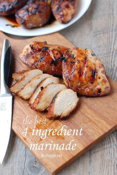 sliced chicken on a cutting board next to a knife