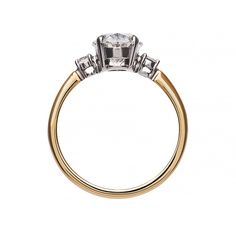 a three stone diamond engagement ring on a white background