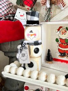 a christmas scene with snowmen, santa clause and other holiday decorations on a shelf