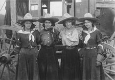 an old photo of three women in cowboy hats posing for a picture with another woman