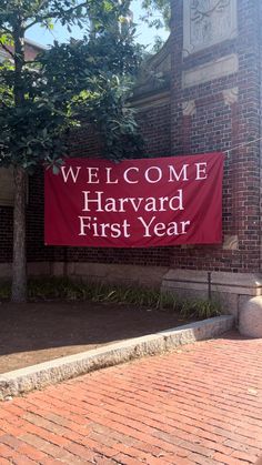 a welcome sign in front of a brick building