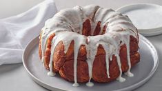 a bundt cake with white icing on a plate