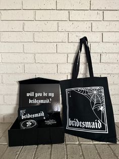 two black bags sitting on top of a brick floor next to a white brick wall