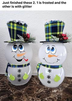 two snowmen wearing hats and scarves on top of a counter with the caption, just finished these 2 1 is frosted and the other is with glitter