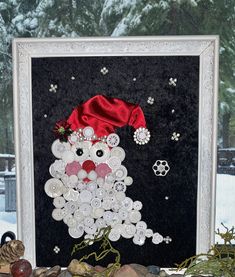 a picture frame with buttons on it and a snowman made out of buttons in the background