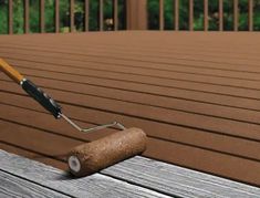 a paint roller on top of a wooden deck