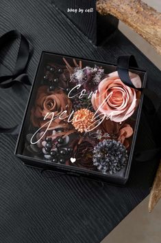 a black box with flowers and words on it