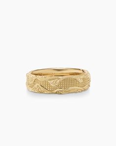 a yellow gold wedding band with an intricate design