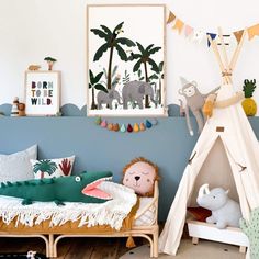 a child's room with toys and decor on the walls, including a teepee tent