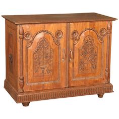 an old wooden cabinet with carvings on the doors