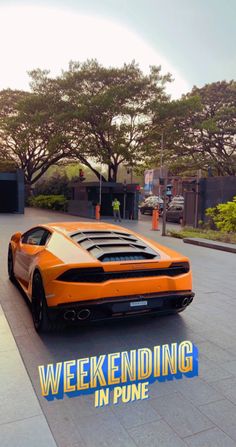 an orange sports car parked in front of a parking garage with the words week ending in blue