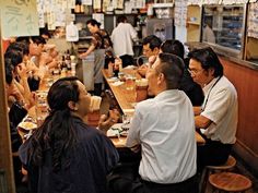 a group of people sitting around a table eating food