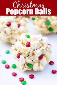 white chocolate popcorn balls with candy sprinkles scattered around them on a white surface