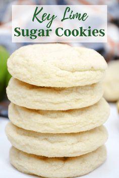 a stack of key lime sugar cookies sitting on top of a white plate next to an apple