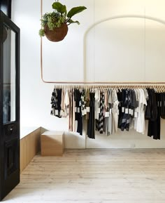 a rack with clothes hanging from it in a room