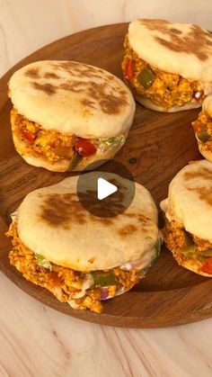 four quesadillas sitting on top of a wooden plate