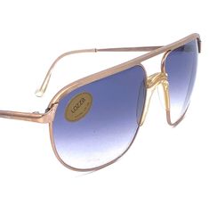 Lozza Linea Profilo 1 14 karats rolled gold matte finish aviator sunglasses hand crafted in Italy in the 70s, brand new and unworn from an optician deadstock and coming in authentic Lozza pouch bag. Finest quality, luxurious real rolled gold frames with clear acetate nose bridge and matching temple Tips, fitted with the finest CR39 uva/uvb Lozza fading etched lenses. the most iconic design by Lozza brought in their most exclusive and precious edition. New and unworn from deadstock, in perfect condition, with original pouch.   cal 62/17 Overall 14,5 cm lens 6,2 cm Temple 13,5 cm Luxury Gold Aviator Sunglasses, Gold Retro Aviator Sunglasses With Gradient Lenses, Retro Gold Aviator Sunglasses With Gradient Lenses, Gold Vintage Aviator Sunglasses With Tinted Lenses, Sunglasses Transparent, Gold Frames, Iconic Design, Nose Bridge, Pouch Bag