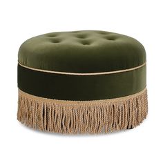 a green velvet ottoman with fringe trim around the top and bottom, on a white background