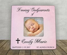 a pink frame with a baby's photo and the words loving godparents of