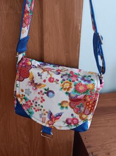 A handy little bag with a saddle style flap that closes with a magnetic stud. Lined interior with zipped pocket. Adjustable strap. Blue Flap Bag With Detachable Strap, School Flap Crossbody Bag With Adjustable Strap, School Crossbody Flap Bag With Adjustable Strap, School Saddle Bag With Detachable Strap, Everyday Saddle Bag With Adjustable Strap And Flap, Daily Use Saddle Bag With Adjustable Strap And Flap, Blue Flap Bag For Daily Use, Everyday Saddle Bag With Magnetic Closure, School Crossbody Flap Bag With Removable Pouch