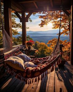 a hammock hanging from the side of a wooden porch