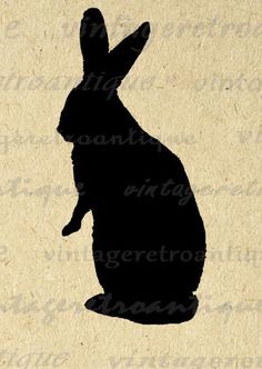 a silhouette of a rabbit sitting on top of a piece of paper