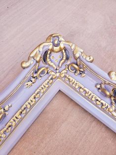 an ornate gold and purple frame on the floor