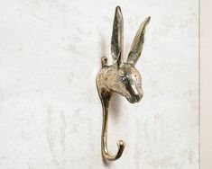 a metal hook on the side of a wall that has a kangaroo head attached to it