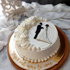 a wedding cake with the bride and groom on it