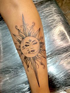 a sun and moon tattoo on the leg