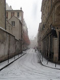 an empty street with snow on the ground