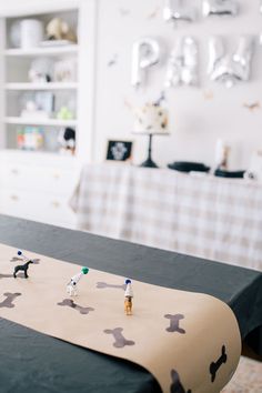 small figurines sitting on top of a table in a room with white walls