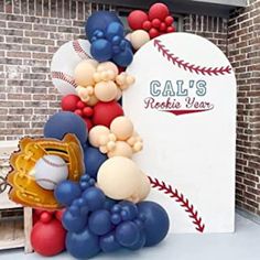 balloons are arranged in the shape of a baseball and catchers mitt on display