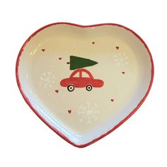 a heart shaped dish with a red car painted on the side and a christmas tree on top