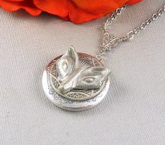 This twilight inspired locket necklace is 30 inches long. Vintage style silver round locket which has engraved floral patterns on the sides; is decorated with a detailed antique finished silver setting, and pewter wolf charm. Pendant is hanging from a antique silver trinity link. I have finished the necklace with silver chain and silver lobster clasp. Locket is 32mm in size. It opens sideways, and has room for two photos! Please note: I DO NOT DO ENGRAVING OR INSERT PICTURES! Thanks for looking: Silver Locket Necklace With Antique Finish, Silver Round Locket Necklace With Antique Finish, Collectible Silver Metal Locket Necklace, Silver Antique Finish Locket Necklace, Antique Finish Silver Metal Locket Necklace, Silver Locket Necklace With Antique Finish As Gift, Adjustable Nickel-free Silver Locket Necklace, Adjustable Silver Locket Necklace, Adjustable Silver Locket Necklace Nickel Free