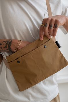 Gaberdine zip-top cross body pouch with adjustable straps & two external pockets. 100% Polyester Made in Osaka, Japan