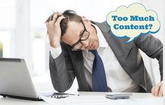 a man sitting at a desk with his head in his hands and the words too much content above him