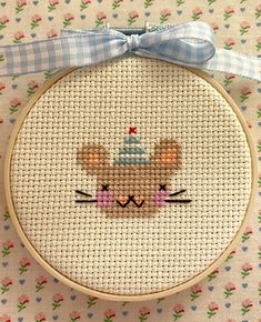 a cross stitch pattern with a bunny holding a birthday cake in it's mouth