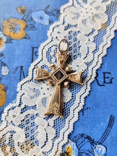 Antique cross pendant, dating from the nineteenth century, rose gold plated, engraved and enameled. There is a religious motif on one side and a floral motif on the other. The cross shows several signs of wear. There are a few chips on the enameled part with a flower. The plating is gone in places and there are small marks and indentations. The cross is very light. Dimensions: about 5.9 cm x 3.8 cm. Possible variations of color due to the light. St Christopher Necklace, Blue Stone Pendant, Silver Filigree, The Cross, Pearl Pendant, Blue Stone, A Flower, Stone Pendants, Pink Gold