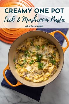 creamy one pot pasta with leek and mushroom pesto in an orange skillet