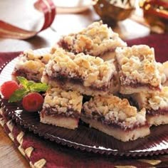 several pieces of dessert on a plate with strawberries