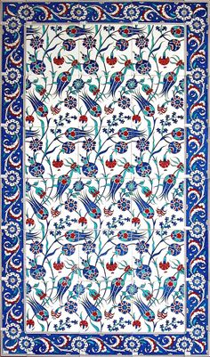 an intricately designed rug with blue, red and white designs on the border is shown