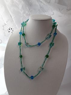 Vintage 1960s Long Lucite Cube Beaded Necklace - Blue, yellow and green Beads. Measures 46 inches long. Closure is a spring clasp. In good used shape. Colors are bright. Please take a look at our photos for overall condition.  Please feel free to ask us any questions you might have about this set! Ships 3-5 business days after purchase via USPS. Thank you so much for visiting our shop! Adjustable Green Beads Long Necklace, Long Green Necklaces For The Beach, Green Long Necklace For Beach, Green Beaded Necklaces With Large Beads For Beach, Green Large Beaded Glass Necklaces, Green Glass Beaded Necklace With Large Beads, Green Long Beaded Necklace With Large Beads, Long Green Beaded Necklace With Large Beads, Green Beach Necklace With Faceted Beads