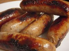 several sausages on a white plate ready to be eaten