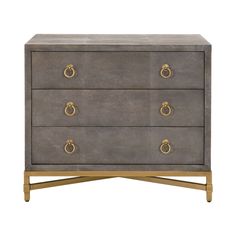 a grey and gold dresser with three drawers on one side, two brass pulls on the other