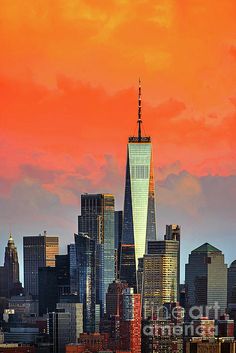 the skyline of new york city at sunset, with one world trade center in the foreground