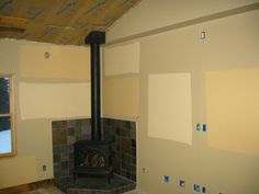 a fireplace in a room that is being remodeled with paint on the walls and around it