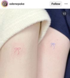 two people with small tattoos on their arms, one is pink and the other is blue